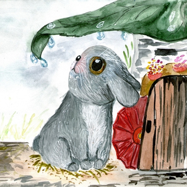 Милый зайчик под листом прячется от дождя