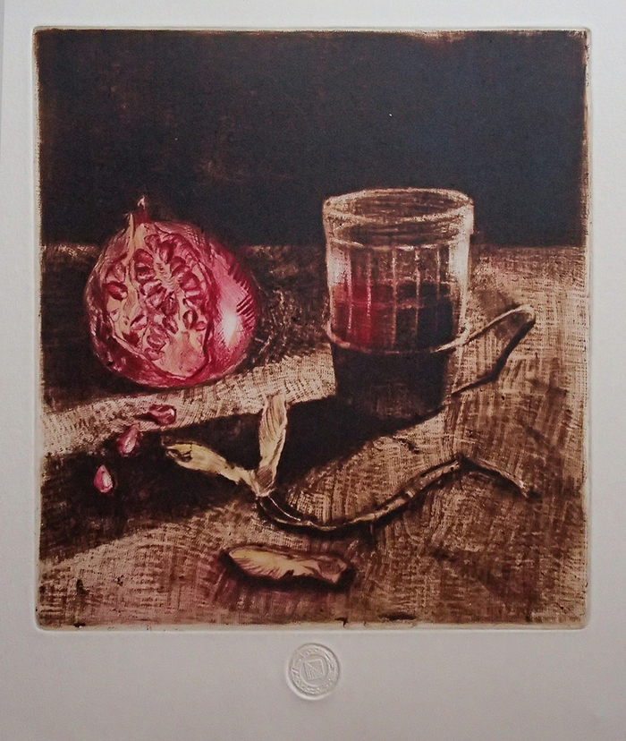 "A cup of tea and a pomegranate"