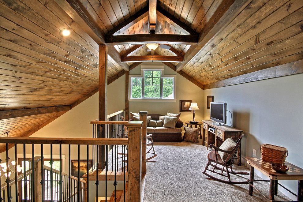 Attic truss for a traditional family room with a wood rocking chair and lake chatuge safe harbor by timberlake custom homes llc
